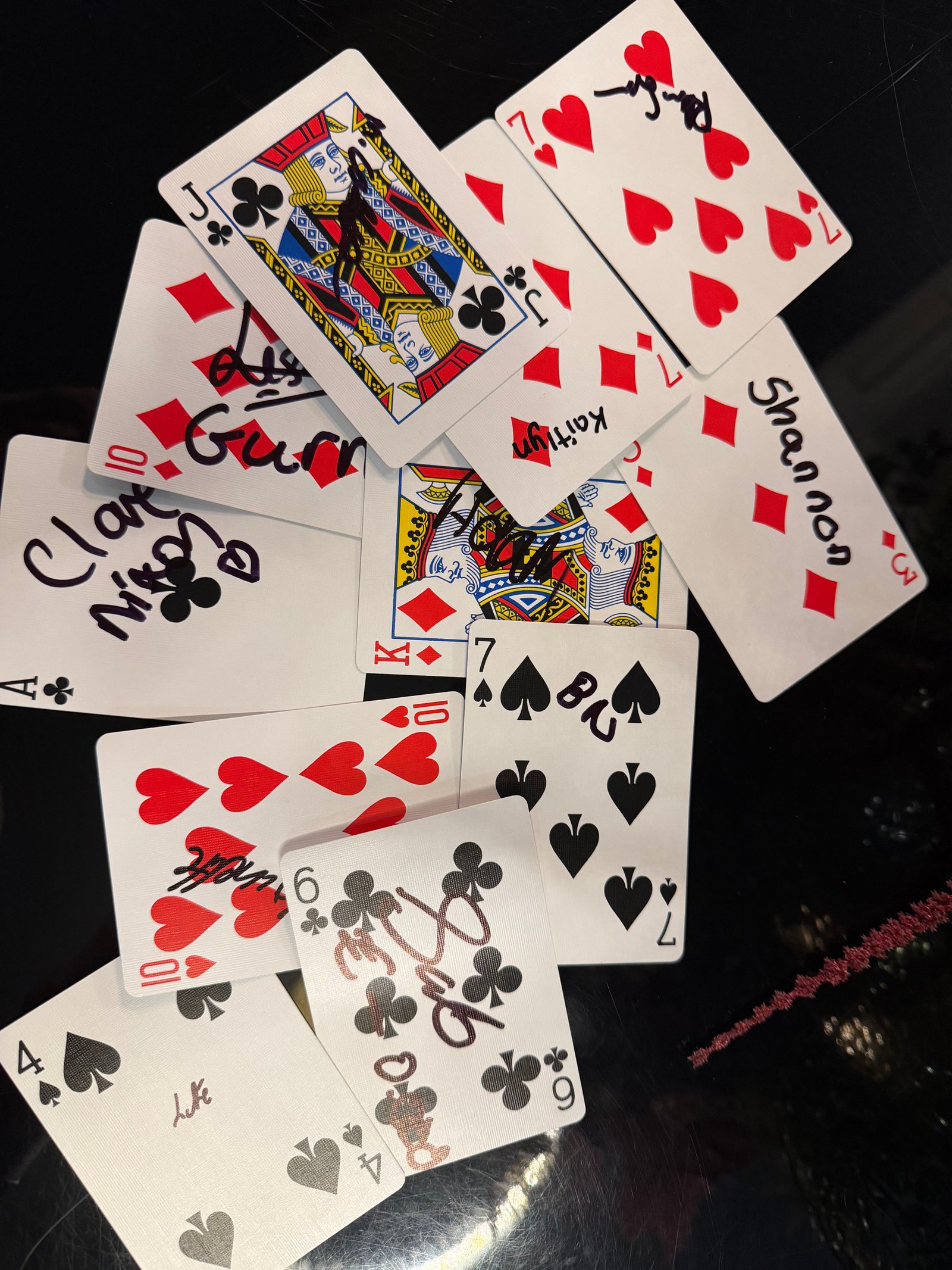 A pile of playing cards signed by guests at Shannon and Brandon's wedding