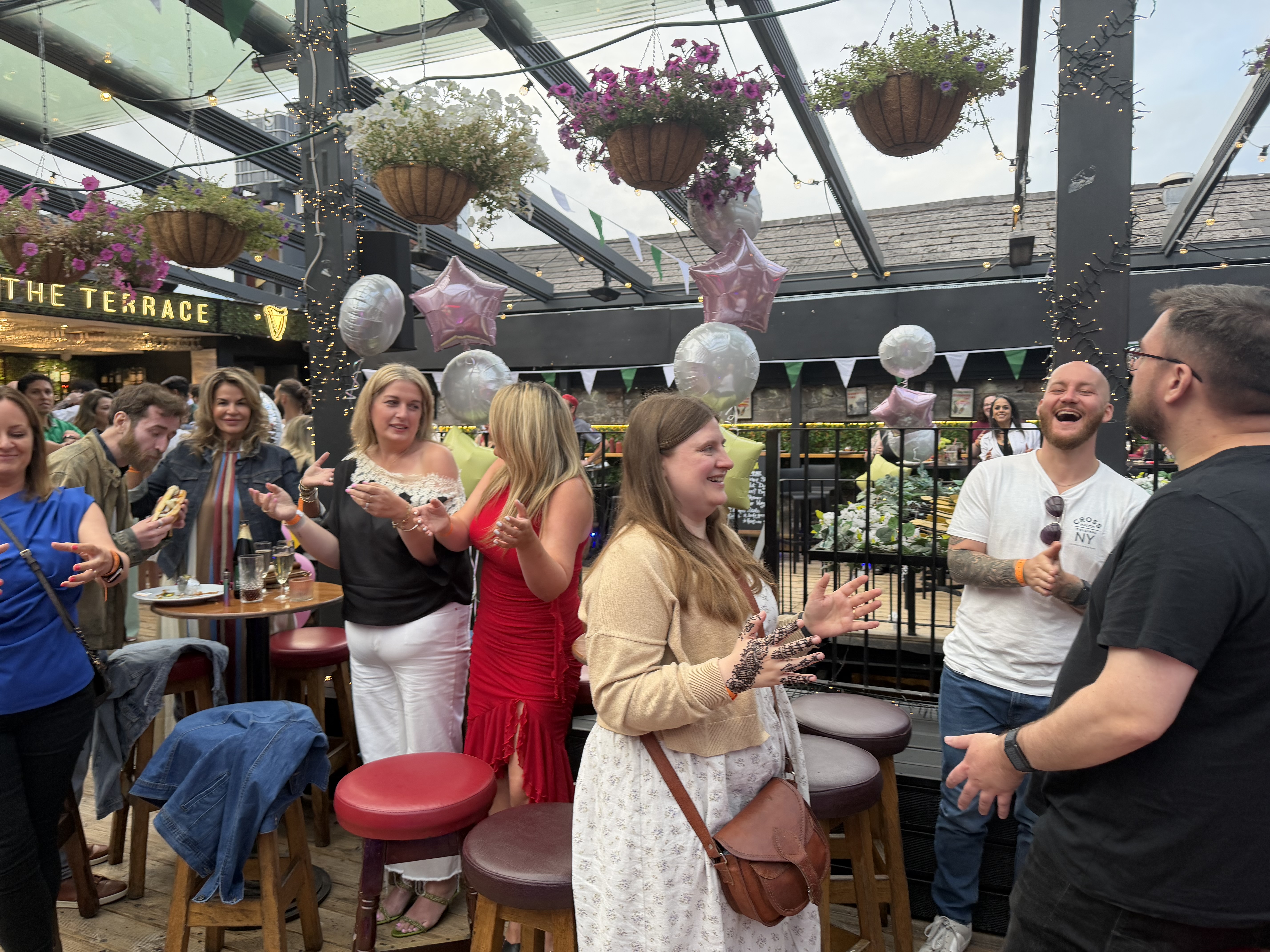 Guests enjoying mind reading entertainment at the WHOOP summer party in Dolans